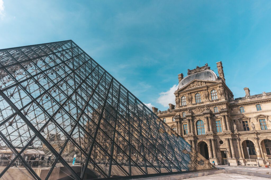 View of the Louvre Museum entrance with the baroque building on the background